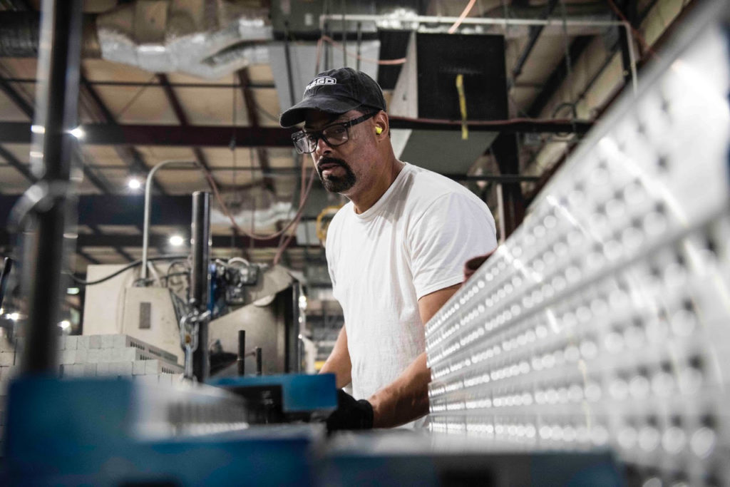 Image of man using machinery in a shop